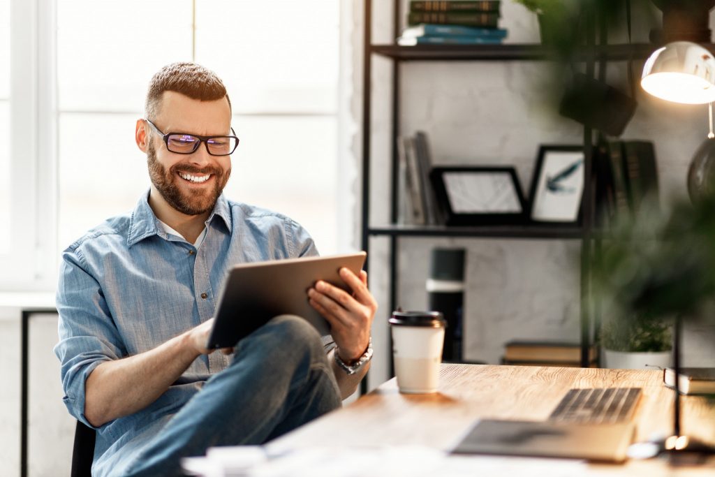 descriptive photo - Man looking at tablet